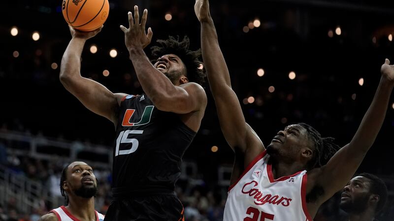 Miami forward Norchad Omier shoots over Houston guard Mylik Wilson in the second half of a...