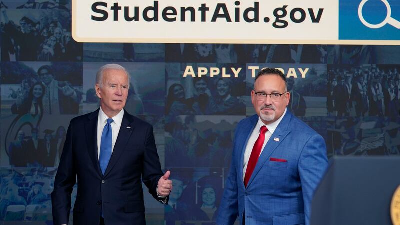 FILE - President Joe Biden answers questions with Education Secretary Miguel Cardona as they...